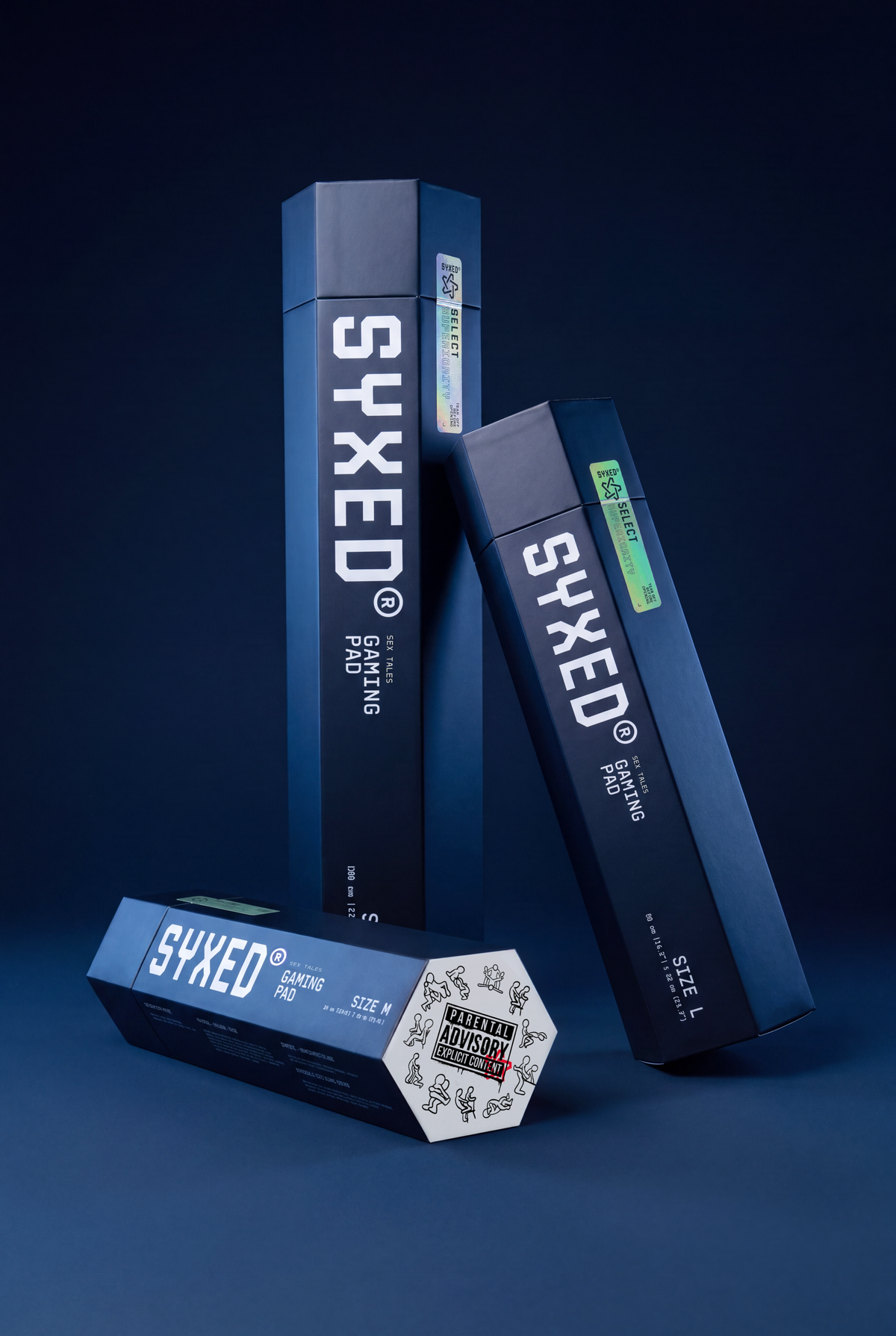 Three dark blue rectangular product boxes for SYXED, including a standing box, a leaning box, and a horizontal box on a dark blue studio background.