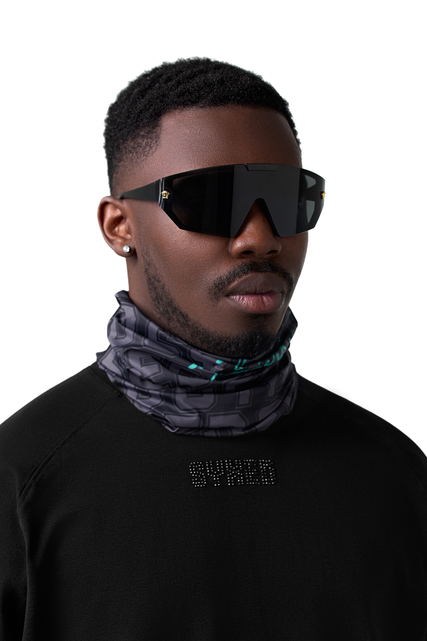 Man wearing black neck gaiter and a dark shirt with text on a white background