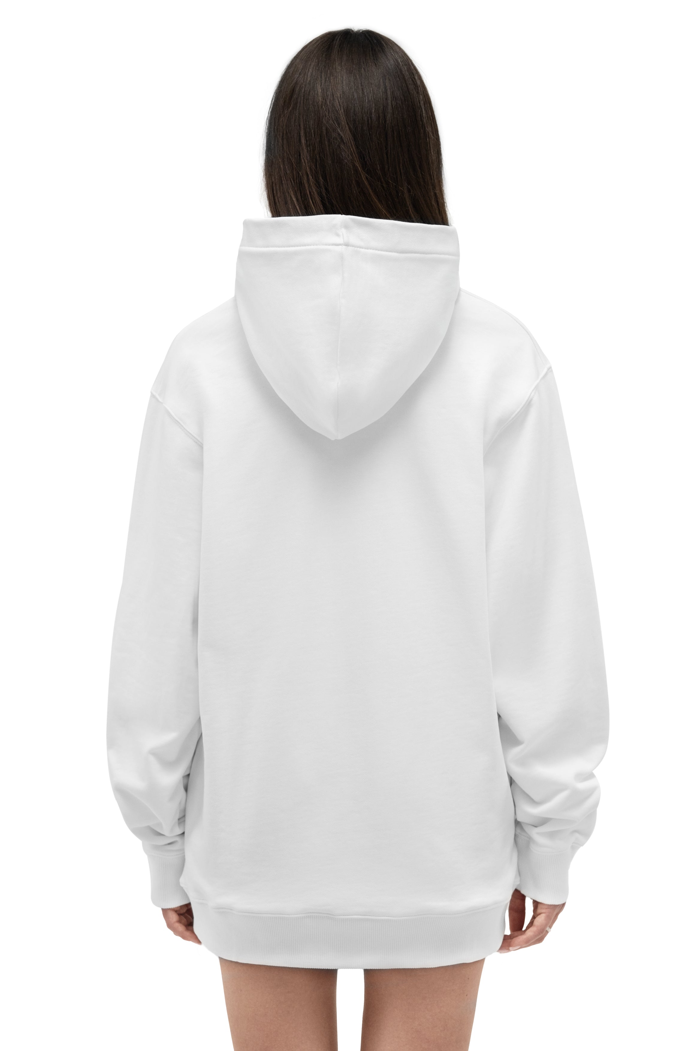 A person viewed from the back wearing an oversized white pullover hoodie against a plain white background.