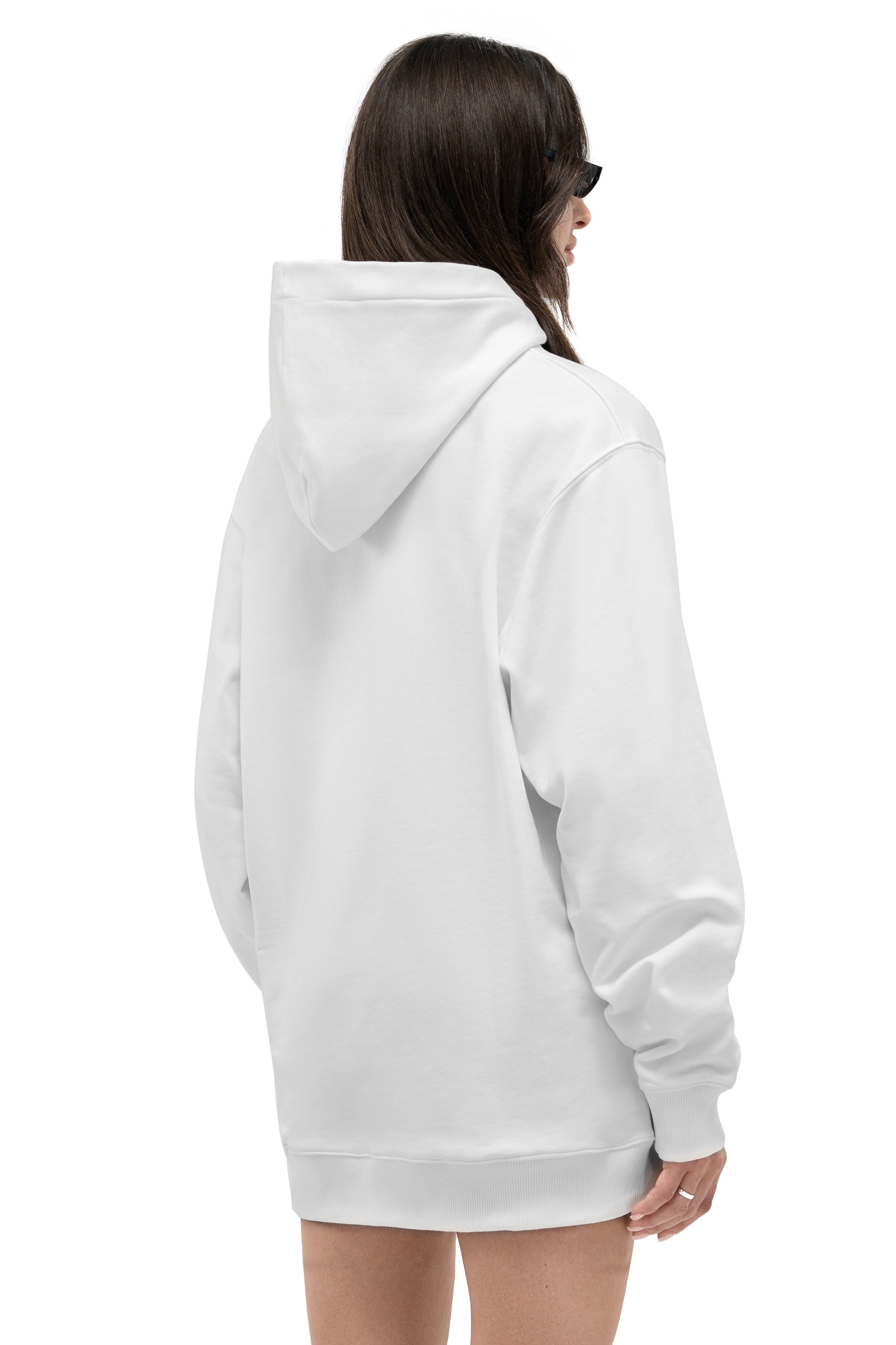 A woman shown from the back wearing an oversized white pullover hoodie against a plain white background.