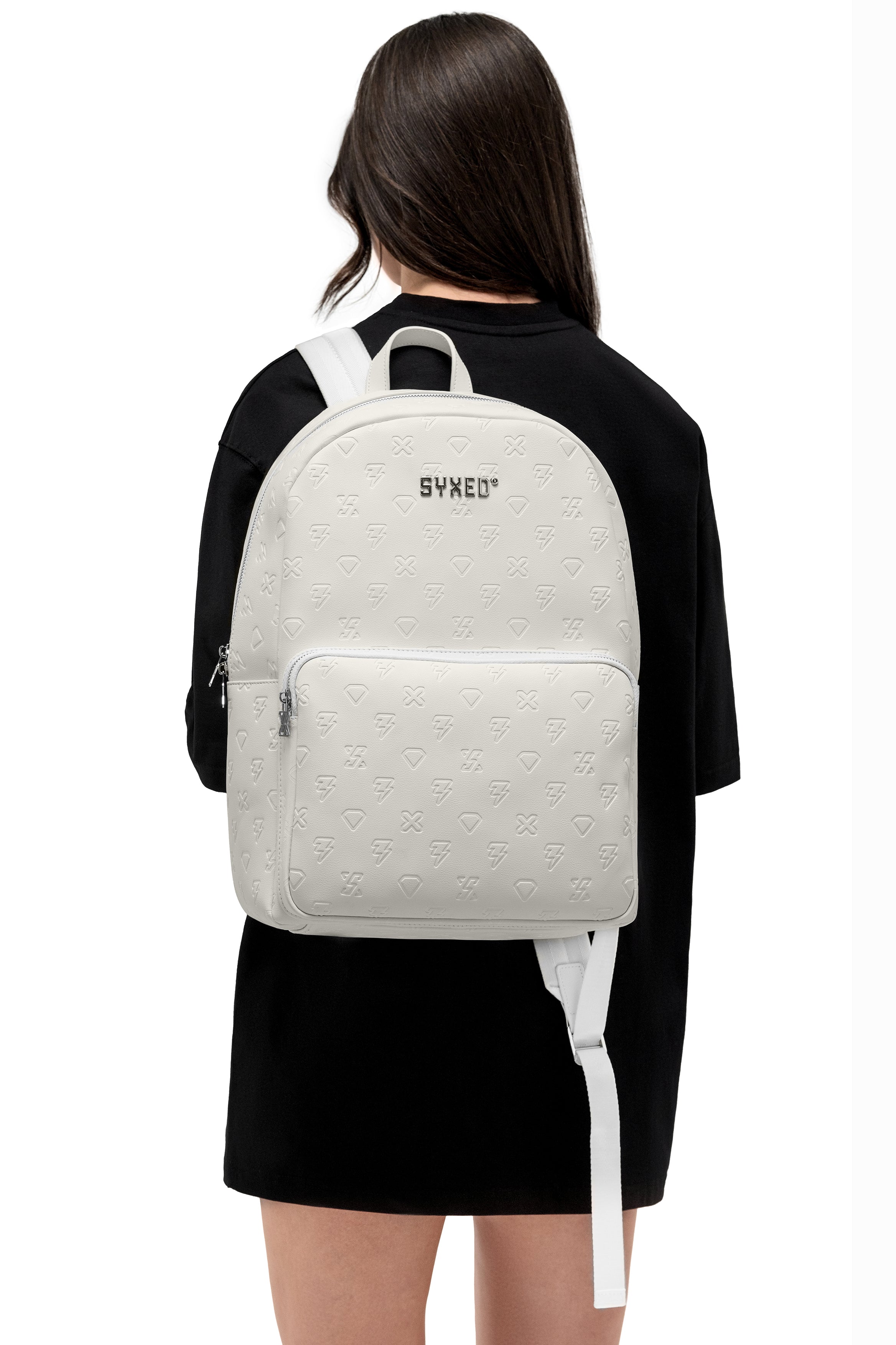 a white embossed-textured backpack with the brand name 'SYXED' printed on the front.